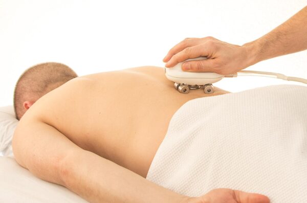 How does massage assist with back pain?